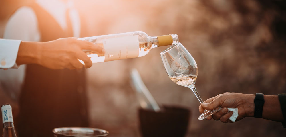 Glass of rose wine being poured