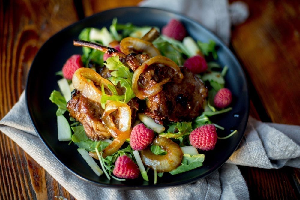 Roast lamb on top of salad